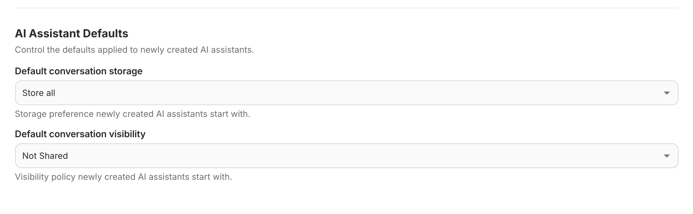 The AI Assistant Defaults section with the default conversation storage and default conversation visibility selects